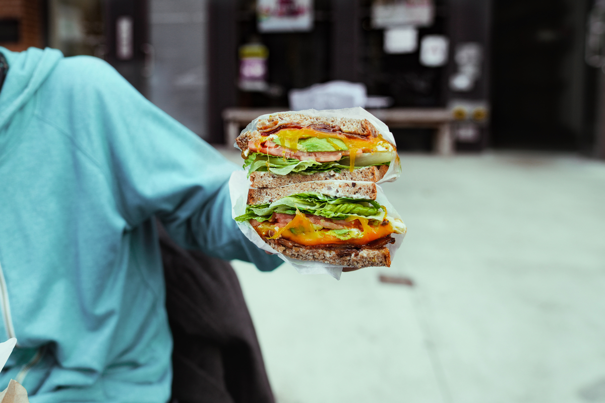 man holding big portion sandwich outside closeup 2022 02 03 11 53 13 utc